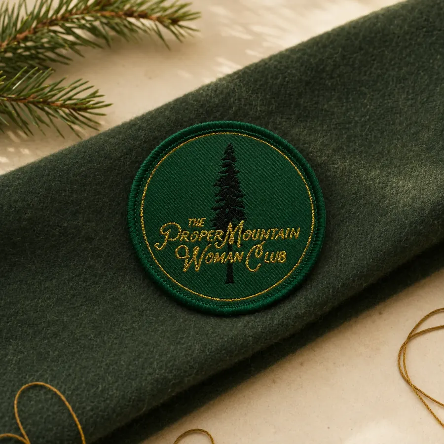 The club patch, stitched in gold on green wool